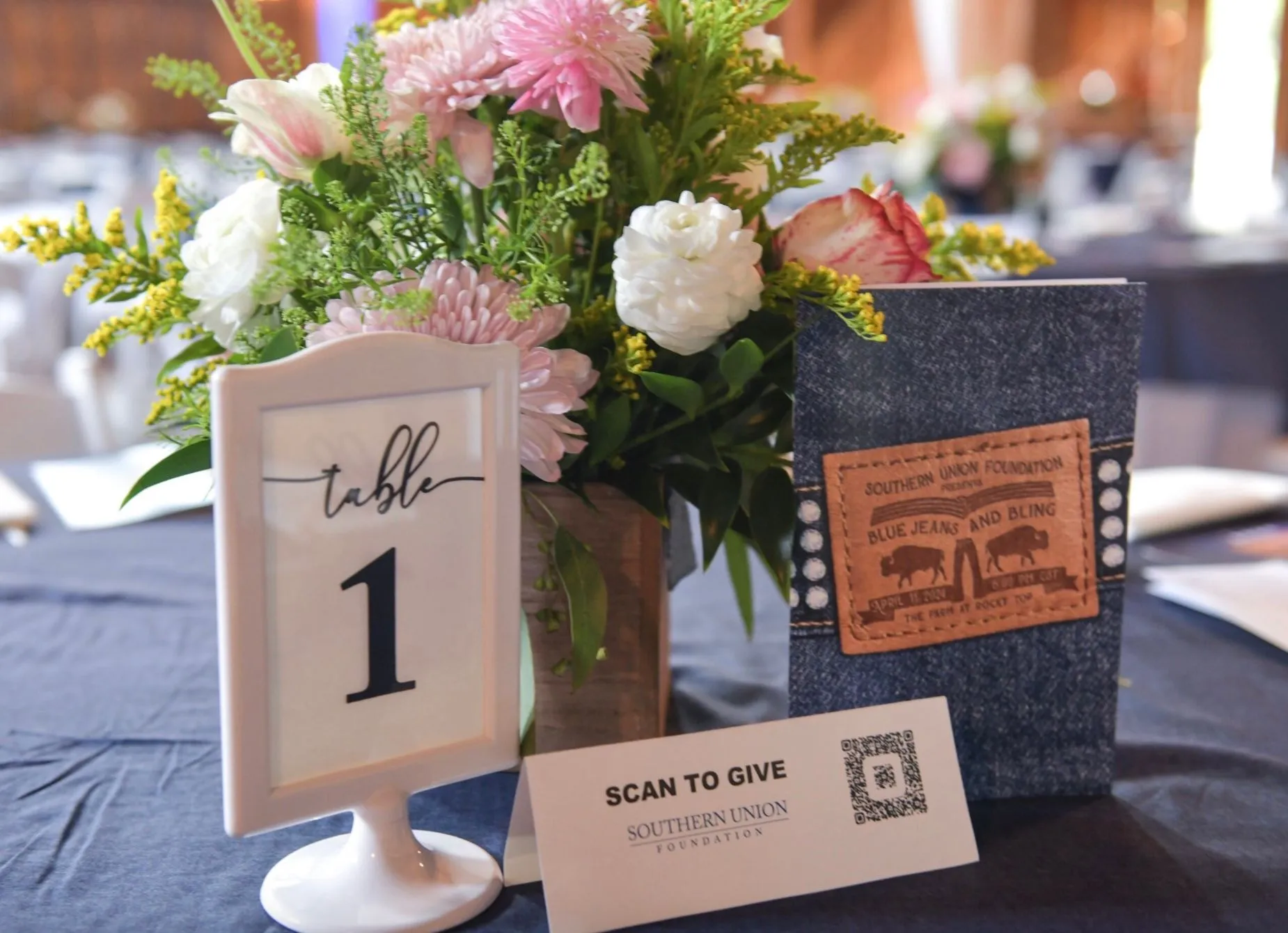 Table decorated with flowers and memorabilia